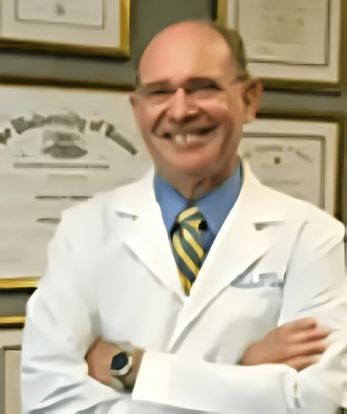 A man in white lab coat with arms crossed.