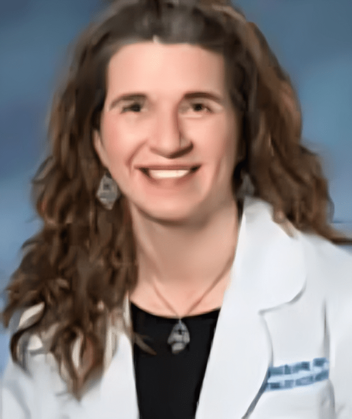 A woman in white coat smiling for the camera.