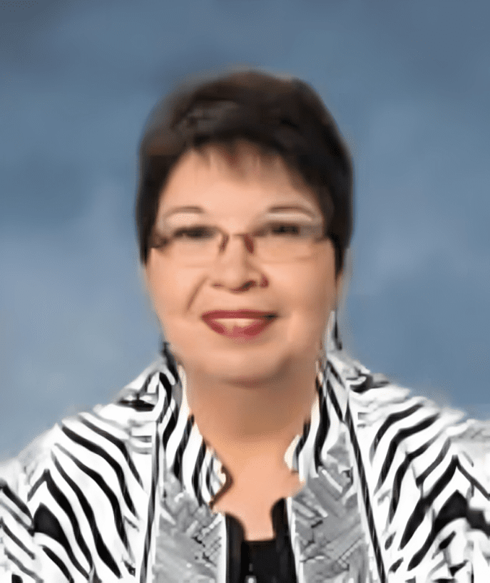 A woman with glasses and zebra print shirt.