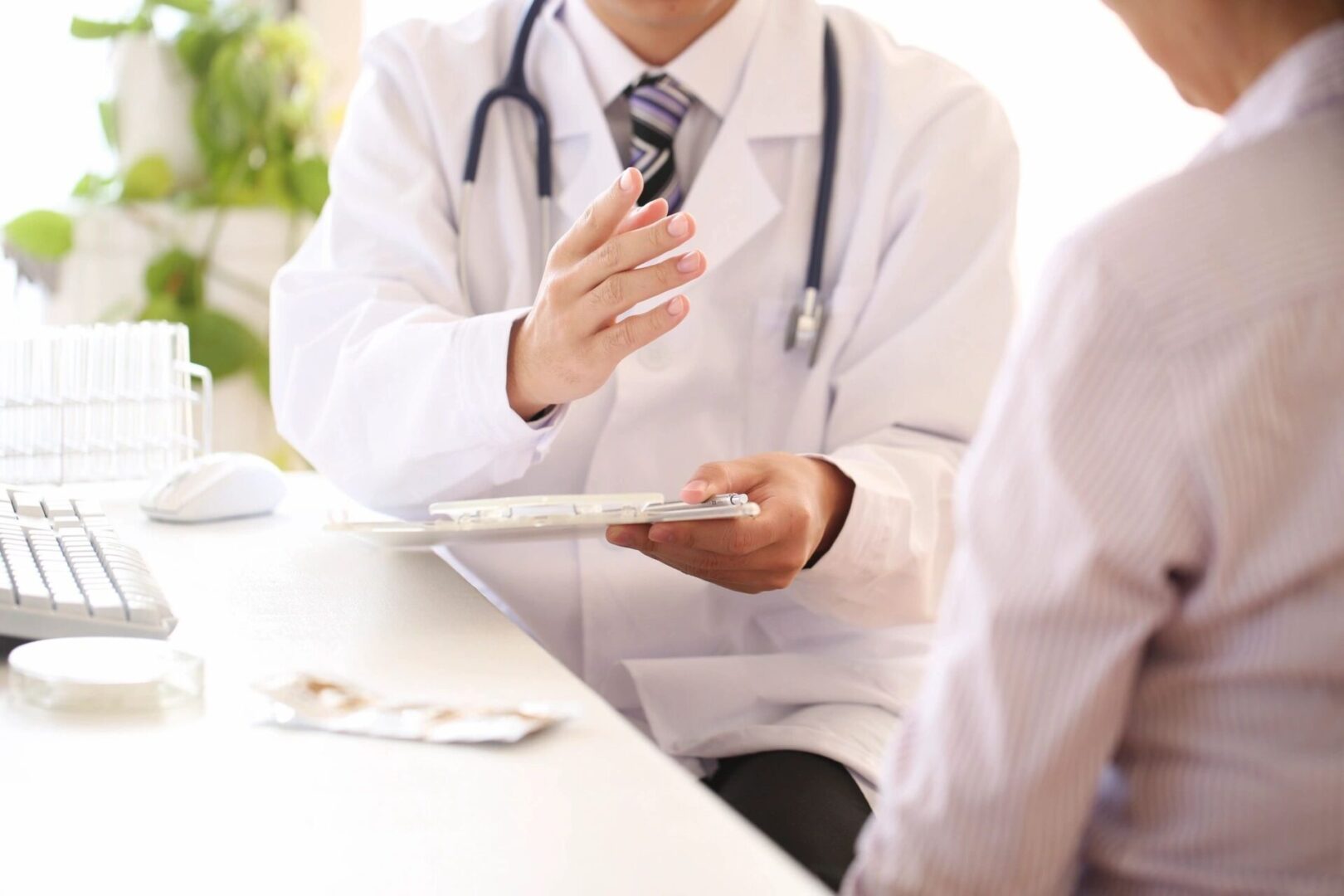 A doctor is holding his hand out to someone